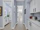 Hallway with light wood flooring, gray walls, and white cabinets at 11 Feather Sound Dr, Henderson, NV 89052