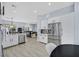 Bright kitchen features stainless steel refrigerator, light wood flooring and adjacent seating area at 11 Feather Sound Dr, Henderson, NV 89052