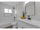 A renovated bathroom features white subway tile, modern fixtures, and a floating vanity with a sleek mirror at 1424 Balzar Ave, Las Vegas, NV 89106