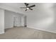 Bright bedroom features neutral carpet, ceiling fan, and multiple entry doors at 1424 Balzar Ave, Las Vegas, NV 89106