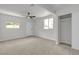Bedroom features multiple windows, neutral carpet, ceiling fan, and closet at 1424 Balzar Ave, Las Vegas, NV 89106