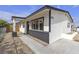 Inviting home exterior with a covered porch, contrasting trim, and desert landscaping at 1424 Balzar Ave, Las Vegas, NV 89106