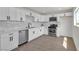 Bright, updated kitchen featuring new stainless steel appliances and sleek white cabinetry at 1424 Balzar Ave, Las Vegas, NV 89106
