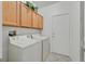 A well-lit laundry room with a washer, dryer, and storage cabinets above at 1846 High Mesa Dr, Henderson, NV 89012