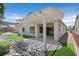 Covered patio with stone landscaping, providing shade and a relaxing outdoor space at 1846 High Mesa Dr, Henderson, NV 89012