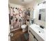 Charming bathroom with colorful shower curtain, modern vanity, and wood-look flooring at 2171 Bay Club Dr # 103, Laughlin, NV 89029