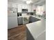 Well-lit kitchen featuring updated appliances, gray cabinets, and wood-look flooring at 2171 Bay Club Dr # 103, Laughlin, NV 89029