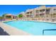 Inviting community pool with lounge chairs and shade under a bright blue sky at 2171 Bay Club Dr # 103, Laughlin, NV 89029