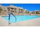 Community pool at condo complex with lounge chairs and a blue safety handrail entry point at 2171 Bay Club Dr # 103, Laughlin, NV 89029