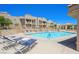 Community pool with clear blue water and lounge chairs for residents at 2171 Bay Club Dr # 103, Laughlin, NV 89029