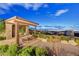 Relaxing backyard space featuring an open-air lounge, seating, and desert-style landscaping at 2180 Skyline Heights Ln, Henderson, NV 89052