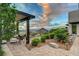 Stunning backyard patio with a view, lush landscaping, and an open-air pergola lounge at 2180 Skyline Heights Ln, Henderson, NV 89052