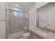 Modern bathroom featuring a glass shower, neutral tile, and sleek vanity at 2180 Skyline Heights Ln, Henderson, NV 89052