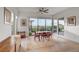 Inviting dining area with large windows offering scenic views, complemented by elegant decor and hardwood flooring at 2180 Skyline Heights Ln, Henderson, NV 89052