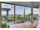 Bright dining room with mountain views visible from ample windows and lush outdoor landscaping at 2180 Skyline Heights Ln, Henderson, NV 89052