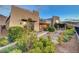 A modern home's exterior with manicured desert landscaping and an outdoor seating area at 2180 Skyline Heights Ln, Henderson, NV 89052