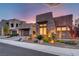 Contemporary home showcasing stone facade, modern design, manicured landscaping, and stylish garage door at 2180 Skyline Heights Ln, Henderson, NV 89052