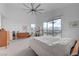 Bright main bedroom featuring carpeted floors, vaulted ceilings, and a large window with mountain views at 2180 Skyline Heights Ln, Henderson, NV 89052