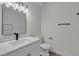Well-lit bathroom featuring a vanity with a white marble top and black hardware at 2504 Paradise Village Way, Las Vegas, NV 89120