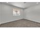 This bedroom features plush carpeting and a view of the outdoors from its well-lit window at 2504 Paradise Village Way, Las Vegas, NV 89120