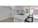 Bright kitchen featuring white cabinets, stainless steel appliances, breakfast bar seating and stylish finishes at 2504 Paradise Village Way, Las Vegas, NV 89120