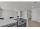 Modern open-concept kitchen with stainless appliances, quartz countertops, and laminate floors at 2504 Paradise Village Way, Las Vegas, NV 89120