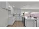 Modern kitchen with sleek appliances, island breakfast bar, white cabinets, and open access to the main living area at 2504 Paradise Village Way, Las Vegas, NV 89120