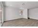 Spacious open-concept living space featuring new laminate floors, recessed lighting, and sliding glass doors to an enclosed back patio at 2504 Paradise Village Way, Las Vegas, NV 89120