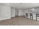 Open-concept living room featuring new laminate floors and a stylish breakfast bar, perfect for entertaining and casual dining at 2504 Paradise Village Way, Las Vegas, NV 89120