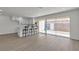Bright living space with modern white kitchen, bar stool seating, new laminate floors, and sliding glass doors to a private backyard at 2504 Paradise Village Way, Las Vegas, NV 89120