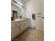 This bathroom has a long vanity, a large mirror, a towel bar, and tile floors at 251 S Green Valley Pkwy # 721, Henderson, NV 89012