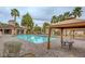 Large community pool with tables under canopies and palm trees, surrounded by pavers, enhancing outdoor enjoyment at 251 S Green Valley Pkwy # 721, Henderson, NV 89012