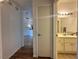 This hallway has wood floors, access to a bathroom, and lighting that provides a clear path through the home at 251 S Green Valley Pkwy # 721, Henderson, NV 89012