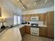 Bright kitchen featuring ample counter space, wooden cabinets, and modern appliances at 251 S Green Valley Pkwy # 721, Henderson, NV 89012