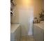 This laundry room has a washer, a dryer, storage shelves, and bright lighting for functionality and convenience at 251 S Green Valley Pkwy # 721, Henderson, NV 89012