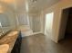 Contemporary bathroom featuring a large vanity, a separate tub, and a glass-enclosed shower at 2947 Caxton Grove Dr, Henderson, NV 89052
