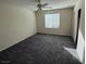 Bright bedroom featuring carpeted floors, a ceiling fan, and natural light from the window at 2947 Caxton Grove Dr, Henderson, NV 89052