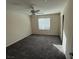 Well-lit bedroom with a ceiling fan, carpeted floor, and a large window at 2947 Caxton Grove Dr, Henderson, NV 89052