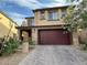 Charming two-story home with brick accents, a wide driveway, and an attached two-car garage at 2947 Caxton Grove Dr, Henderson, NV 89052