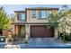 Charming two-story home with brick accents, a wide driveway, and an attached two-car garage at 2947 Caxton Grove Dr, Henderson, NV 89052
