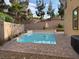 A backyard with a pristine private pool, hardscape and decorative rock, all surrounded by desert landscaping at 2947 Caxton Grove Dr, Henderson, NV 89052