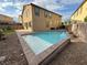 A backyard with a pristine private pool, hardscape and decorative rock, all surrounded by desert landscaping at 2947 Caxton Grove Dr, Henderson, NV 89052