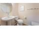 Cozy powder room features a pedestal sink, toilet, and neutral decor at 3088 Bicentennial Pkwy, Henderson, NV 89044