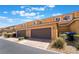 Townhome showcasing attached garages with brick driveways and well-maintained landscaping at 3088 Bicentennial Pkwy, Henderson, NV 89044