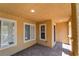 Covered front porch with brick flooring, offering a cozy and sheltered entrance at 3088 Bicentennial Pkwy, Henderson, NV 89044