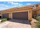 Attached two-car garage with brick-paved driveway and well-maintained exterior at 3088 Bicentennial Pkwy, Henderson, NV 89044
