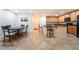 Inviting eat-in kitchen features wood cabinets, island with bar seating, and adjacent dining area at 3088 Bicentennial Pkwy, Henderson, NV 89044