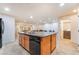 Spacious kitchen island features a dishwasher and sink, complemented by wood cabinetry at 3088 Bicentennial Pkwy, Henderson, NV 89044