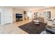 Comfortable living area with plush sofas, a dark accent rug, and seamless flow to the upper level at 3088 Bicentennial Pkwy, Henderson, NV 89044