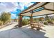Covered picnic area with a wooden table, seating, and walking path at 3088 Bicentennial Pkwy, Henderson, NV 89044